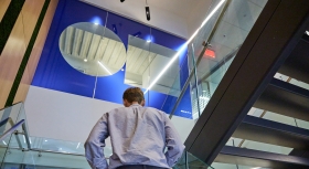 Man walking up stairwell.